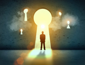 Silhouette of businessman standing in keyhole sun shining above